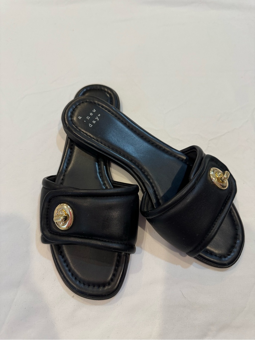 a new day Black Slide Mules with Gold Medallion
